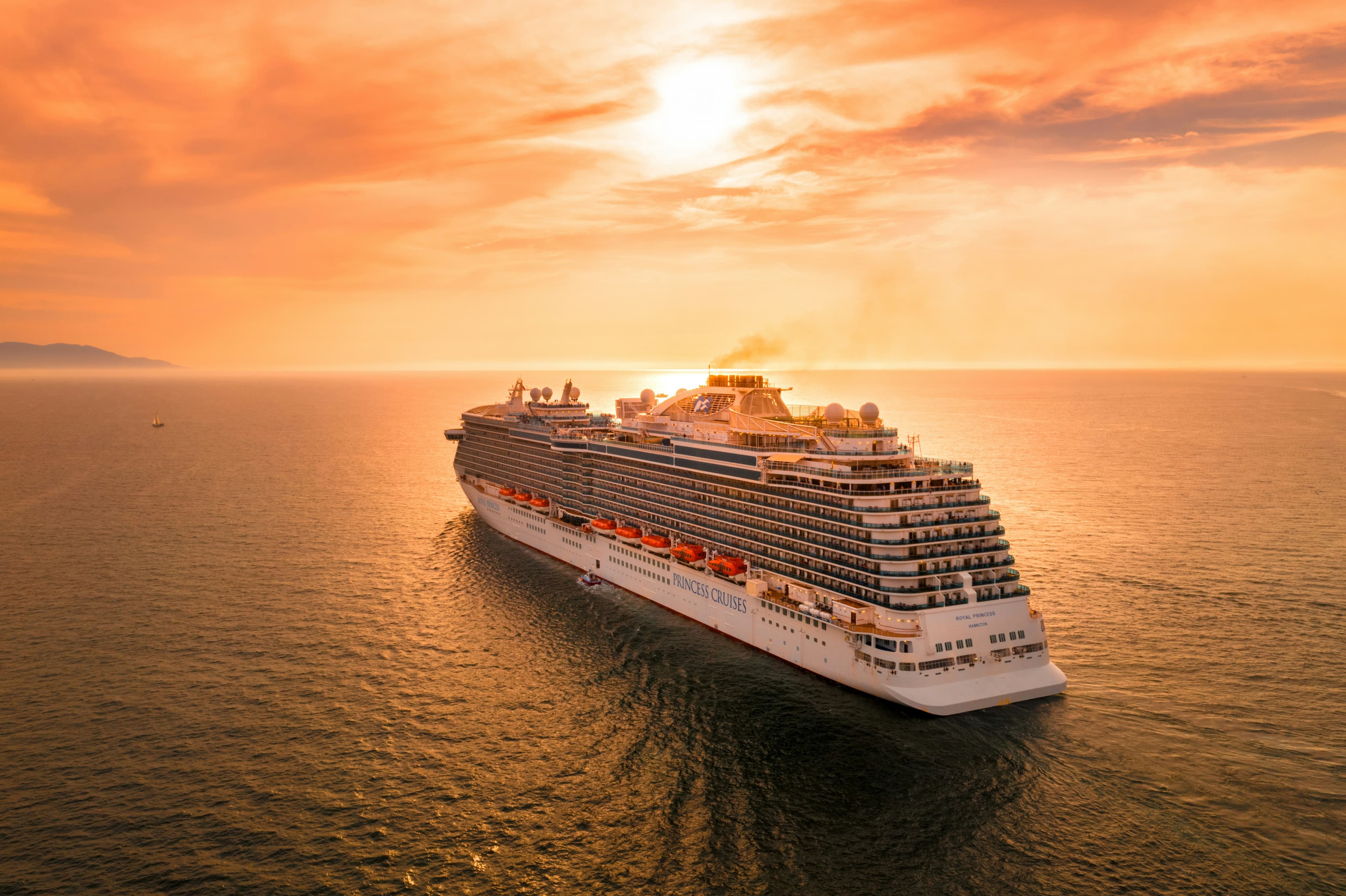 Cruise ship on the ocean at sunset